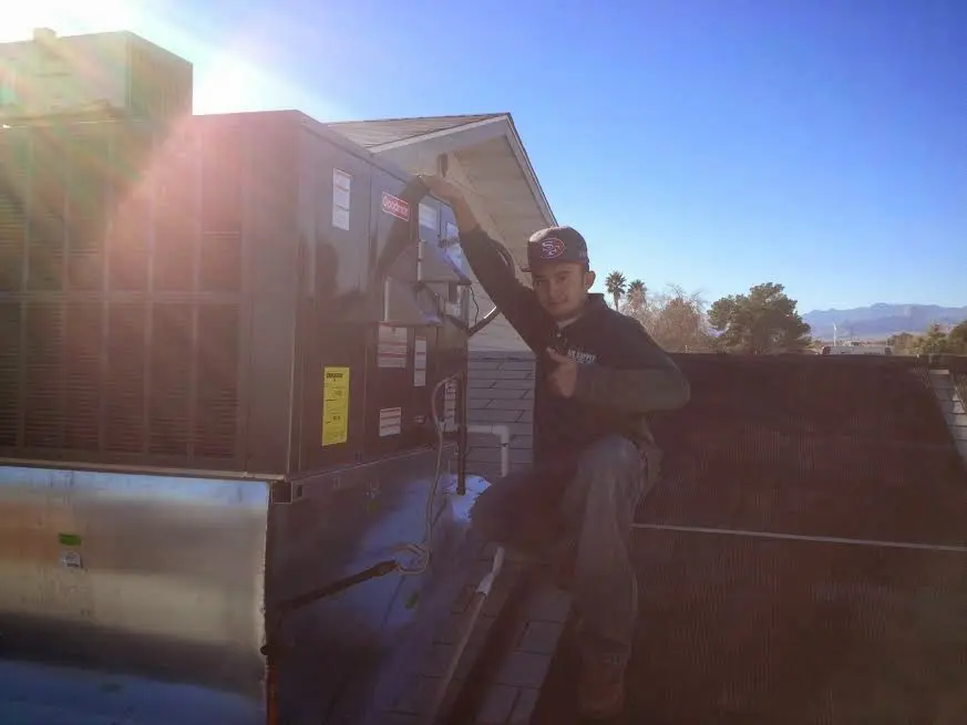 HVAC technician performing HVAC Inspection on a rooftop unit in Gaffney